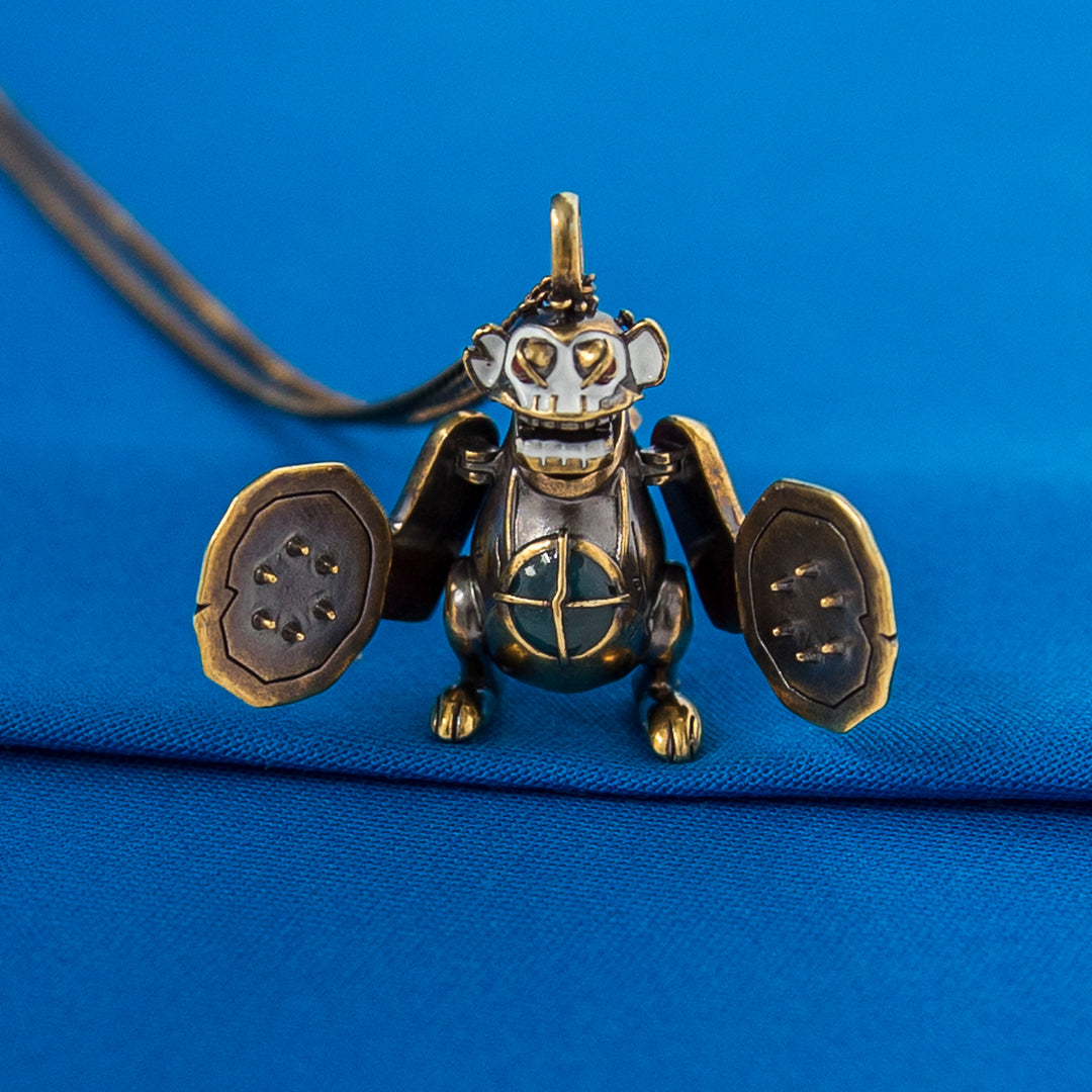 Arcane × RockLove Jinx Monkey necklace with wings open to display interior design and hinge detail.