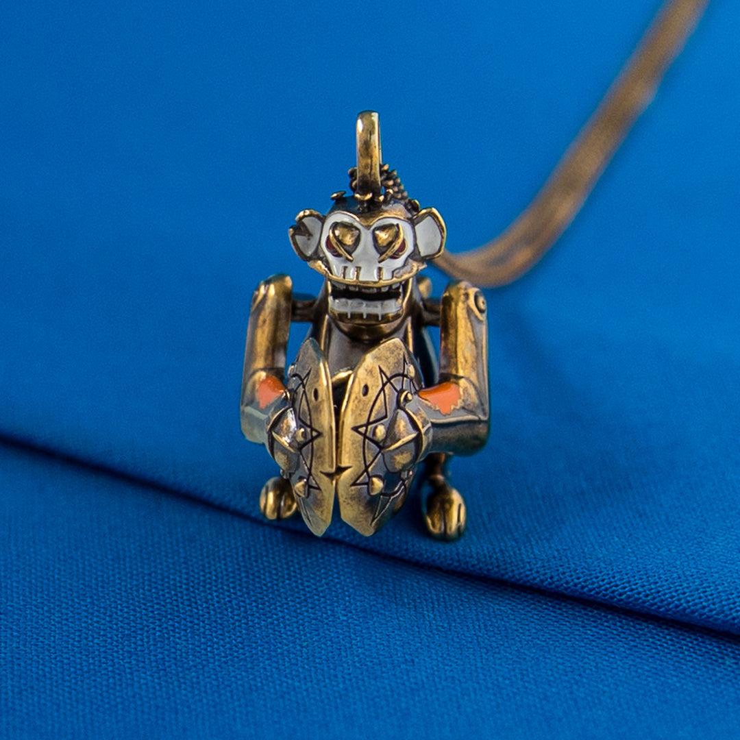 Arcane × RockLove Jinx Monkey pendant displayed on blue background showing front design
