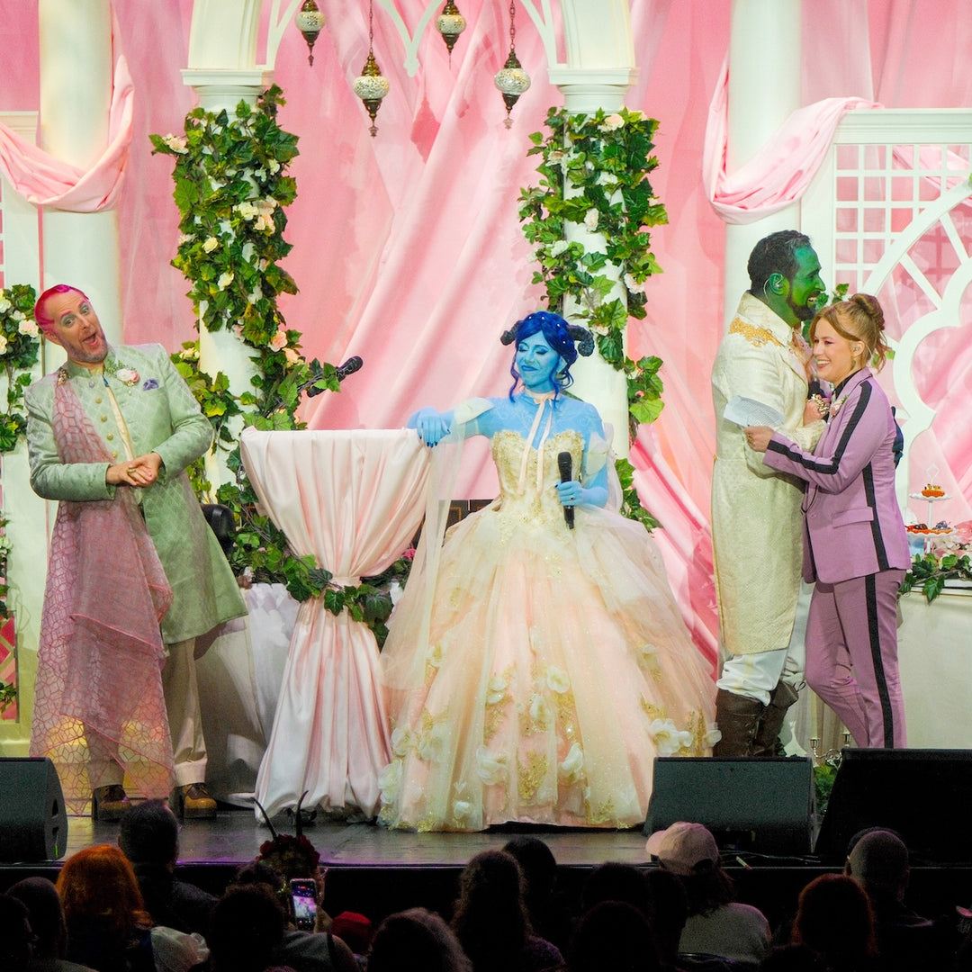 Jester and Fjord wedding stage event with voice actors performing in colorful costumes at Radio City Music Hall in New York City against a pink curtain backdrop