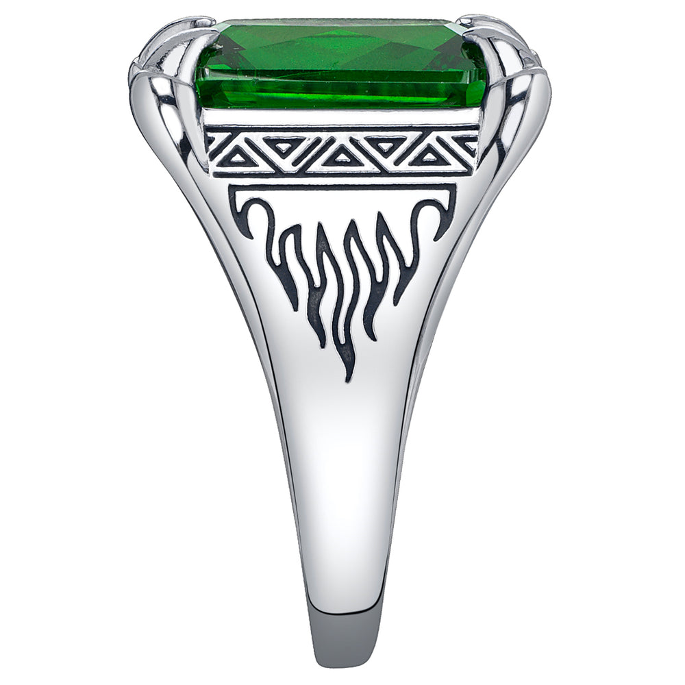 Silver ring with a green gemstone and tribal flame design on a white background