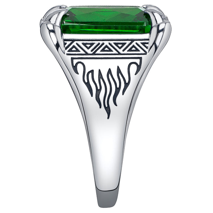 Silver ring with a green gemstone and tribal flame design on a white background