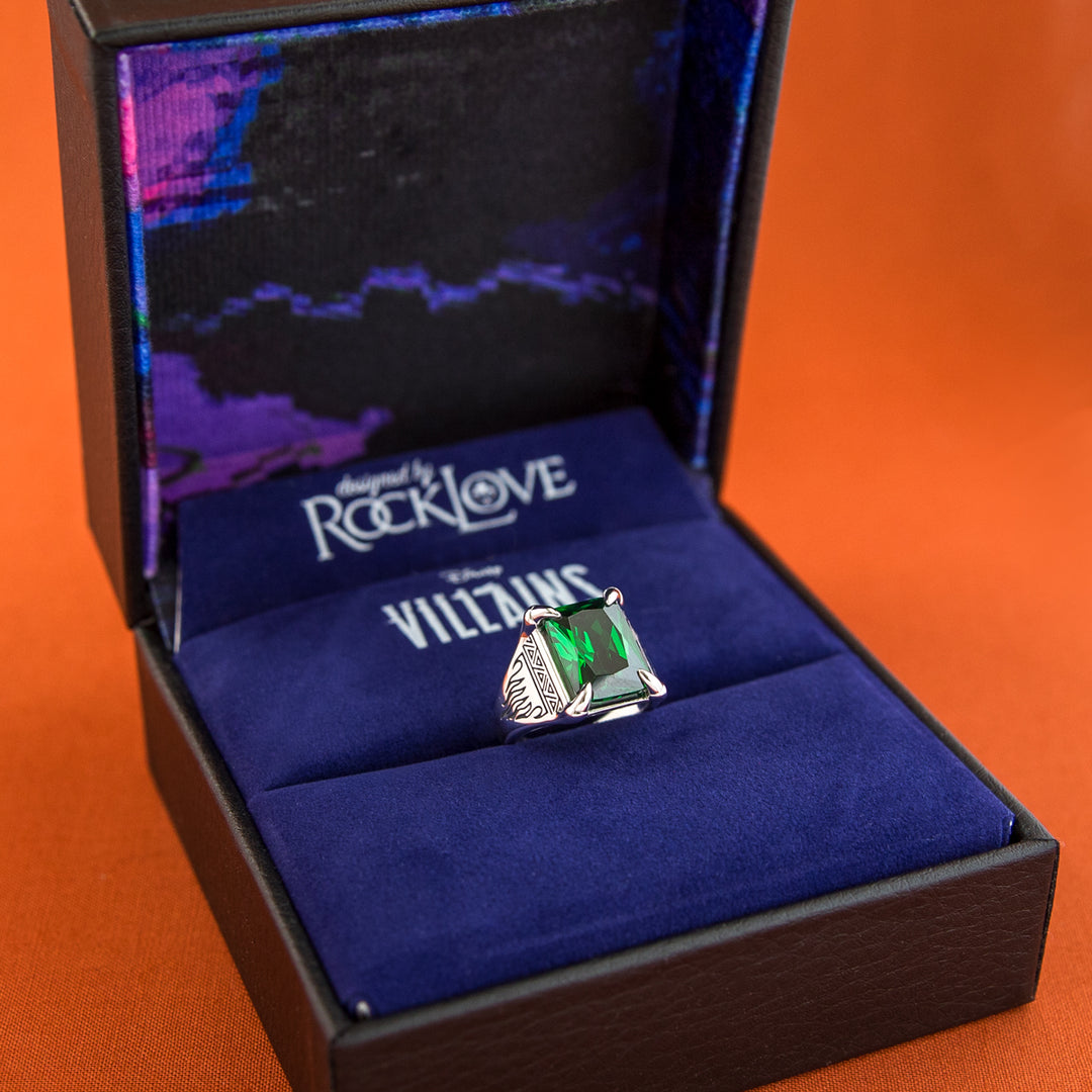 Ring with a green gemstone in a 'RockLove' box on an orange background